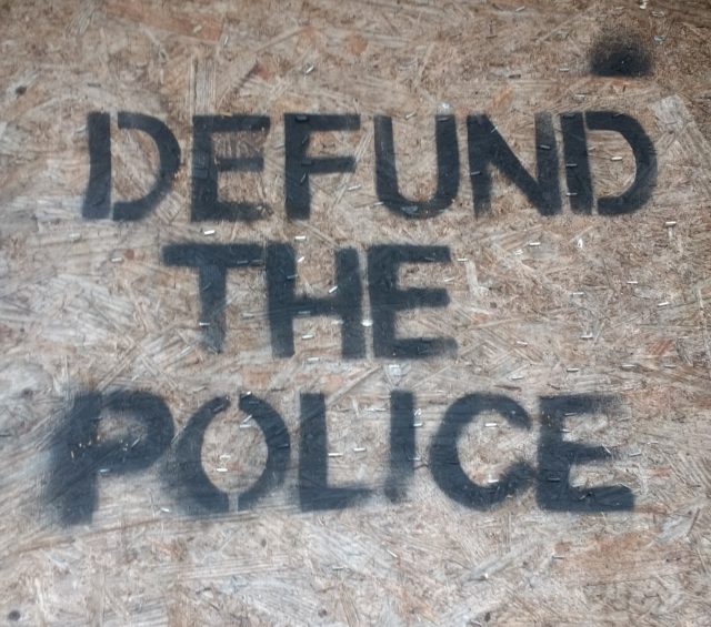 Defund The Police slogan spray painted on a construction site