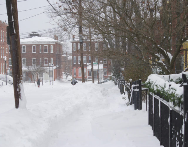 People shoveling snow on Mortson Street 