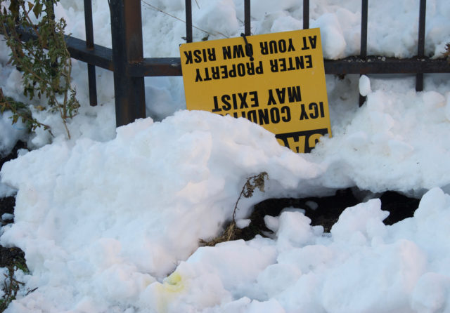 Upside down sign warning about icy conditions