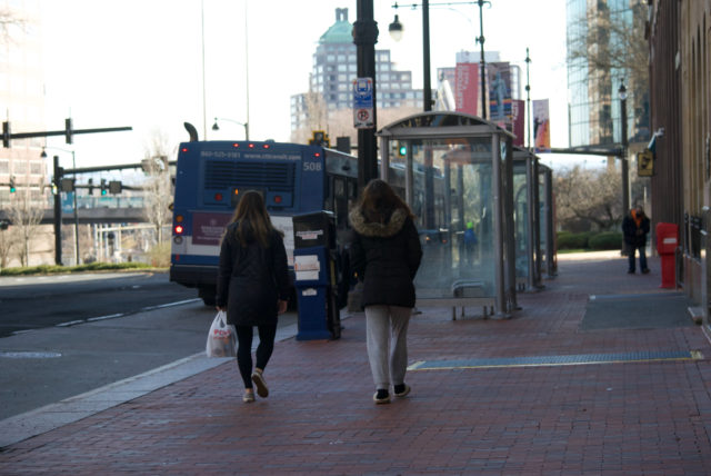Women walking near buses