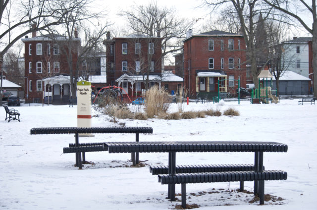 View of picnic tables, playground, and houses