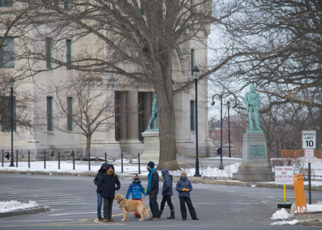 Adults, children, and a golden retriever standing in front of the Connecticut State Capitol