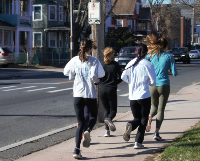 Women jogging on sidewalk