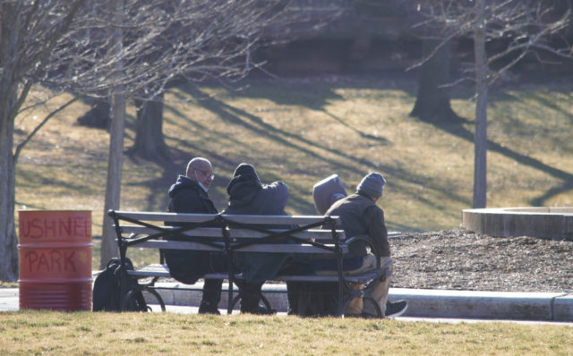 People sitting on a park bench