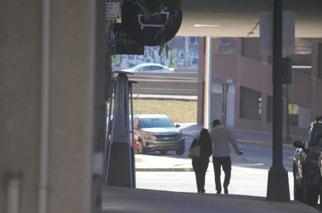 Couple walking on sidewalk