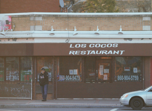 Man standing outside Los Cocos Restaurant