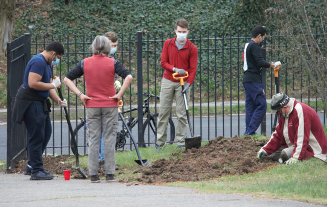People preparing a flower bed in Zion Hill Cemetery