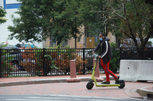 Person riding electric scooter