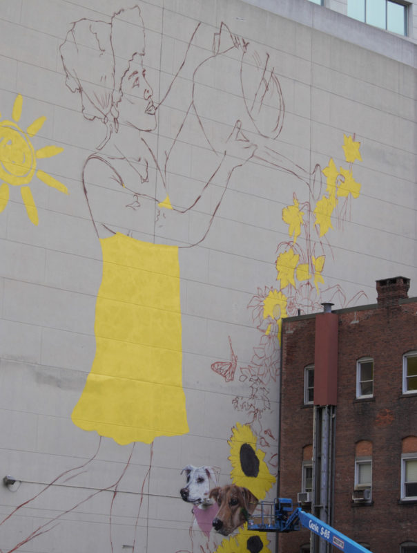 mural in progress: woman watering flowers
