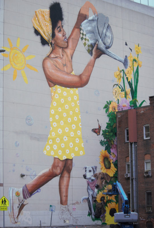 Painting of woman watering flowers