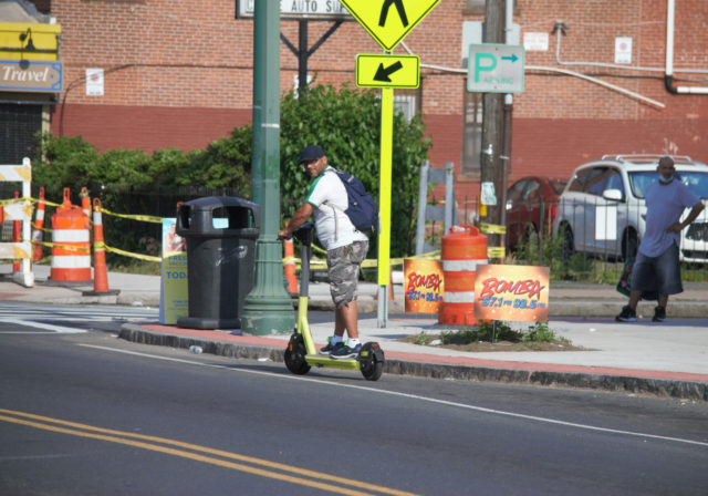 Person riding electric scooter 